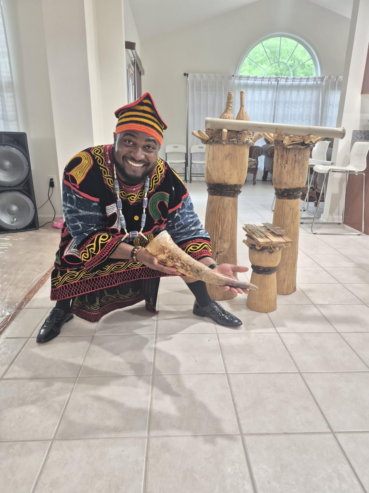 DEM USA member with traditional drums and horn